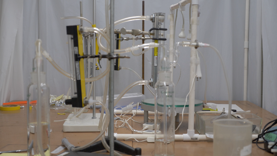 Mostly-glass lab equipment with connective transparent tubing.